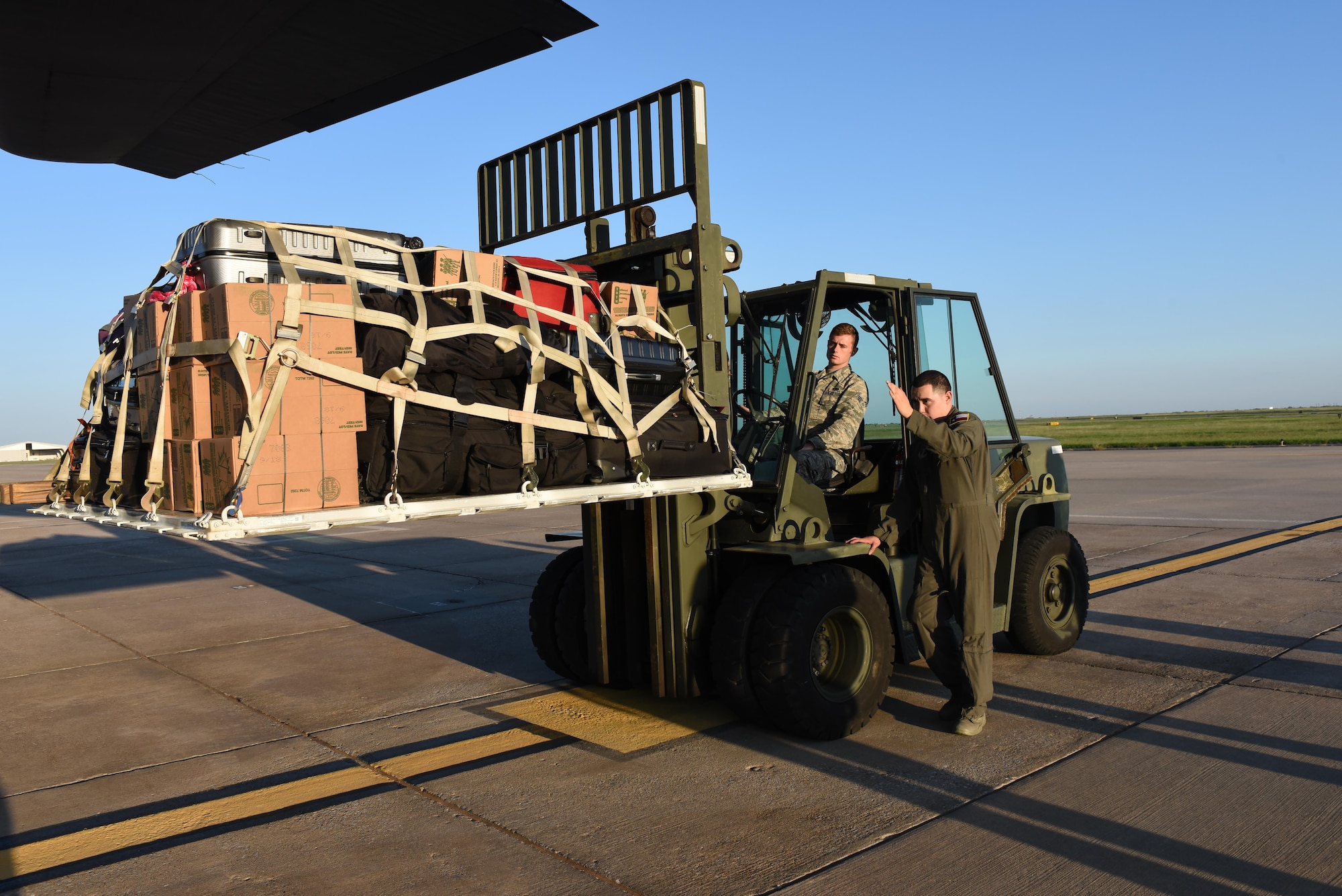 Senior Airman Benjamin Anderson, a 137 SOLRS small air terminal specialist, from Will Rogers Air National Guard Base in Oklahoma City, receives direction from a loadmaster from the 136th Airlift Wing, located at Naval Air Station Fort Worth Joint Reserve Base at Carswell Field, Texas, while loading a pallet of medical equipment and supplies onto a C-130 Hercules from the 136 AW, Aug. 28, 2017, at Will Rogers Air National Guard Base. The 137th Special Operations Wing deployed about 40 medical and aeromedical evacuation Airmen and equipment in support of the Texas Military Department and their relief efforts following Hurricane Harvey. (U.S. Air National Guard photo by Staff Sgt. Kasey Phipps/Released)