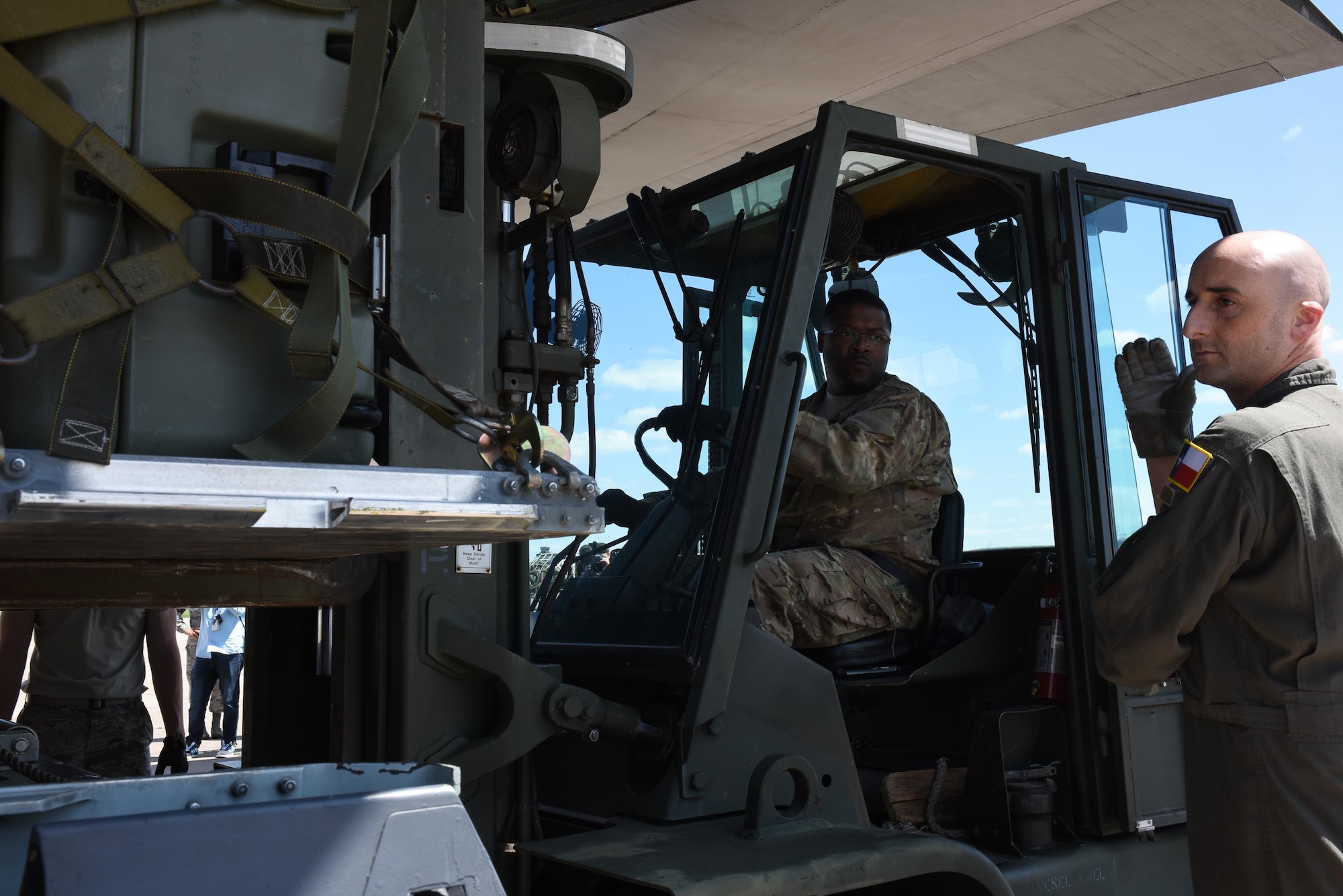 Senior Master Sgt. Alquintin Steele, 137 SOLRS deployment and distribution superintendent from Will Rogers Air National Guard Base in Oklahoma City, receives direction from a loadmaster from the 136th Airlift Wing, located at Naval Air Station Fort Worth Joint Reserve Base at Carswell Field, Texas, while loading a pallet of medical equipment and supplies onto a C-130 Hercules from the 136 AW, Aug. 28, 2017, at Will Rogers Air National Guard Base. The 137th Special Operations Wing deployed nearly 40 medical and aeromedical evacuation Airmen and equipment in support of the Texas Military Department and their relief efforts following Hurricane Harvey. (U.S. Air National Guard photo by Staff Sgt. Kasey Phipps/Released)