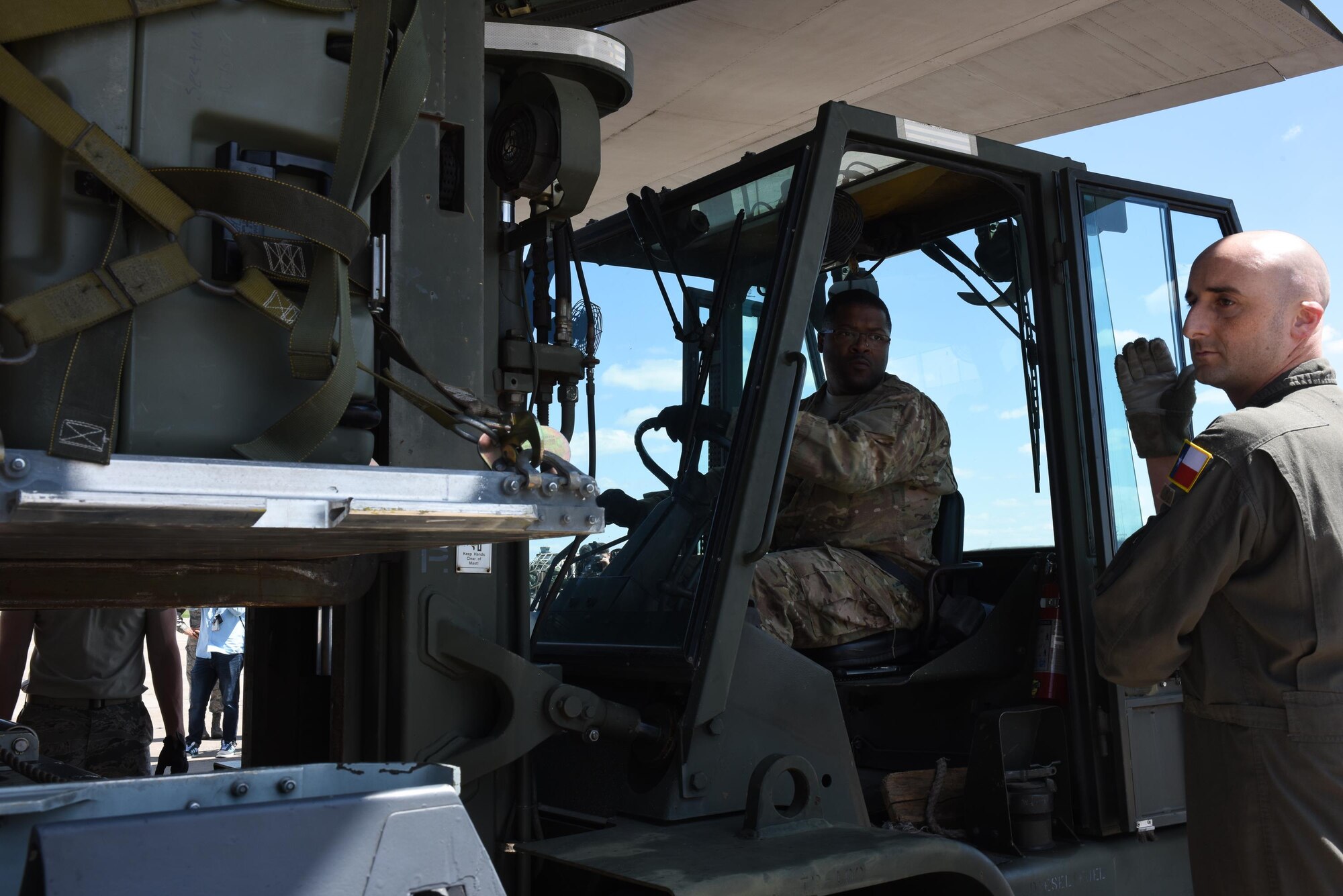 Senior Master Sgt. Alquintin Steele, 137 SOLRS deployment and distribution superintendent from Will Rogers Air National Guard Base in Oklahoma City, receives direction from a loadmaster from the 136th Airlift Wing, located at Naval Air Station Fort Worth Joint Reserve Base at Carswell Field, Texas, while loading a pallet of medical equipment and supplies onto a C-130 Hercules from the 136 AW, Aug. 28, 2017, at Will Rogers Air National Guard Base. The 137th Special Operations Wing deployed nearly 40 medical and aeromedical evacuation Airmen and equipment in support of the Texas Military Department and their relief efforts following Hurricane Harvey. (U.S. Air National Guard photo by Staff Sgt. Kasey Phipps/Released)