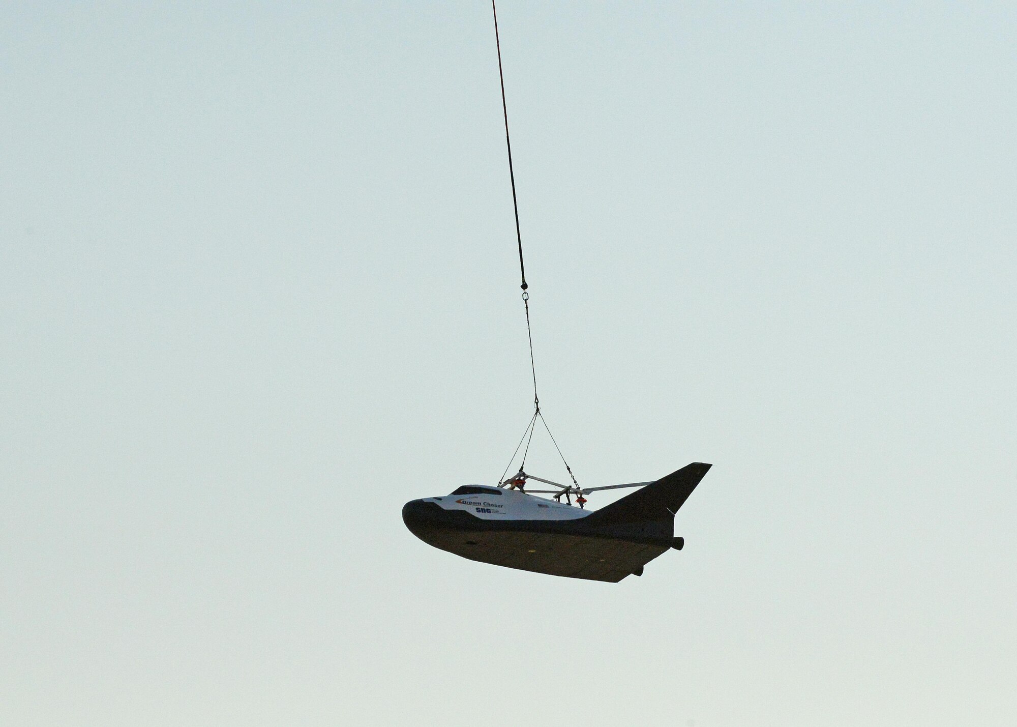 A Columbia Helicopters Model 234-UT Chinook helicopter carries the Dream Chaser over Edwards for a captive carry test Aug. 30. The test was part of the spacecraft’s Phase Two flight test efforts to advance the orbiter closer to space flight. (U.S. Air Force photo by Kenji Thuloweit)