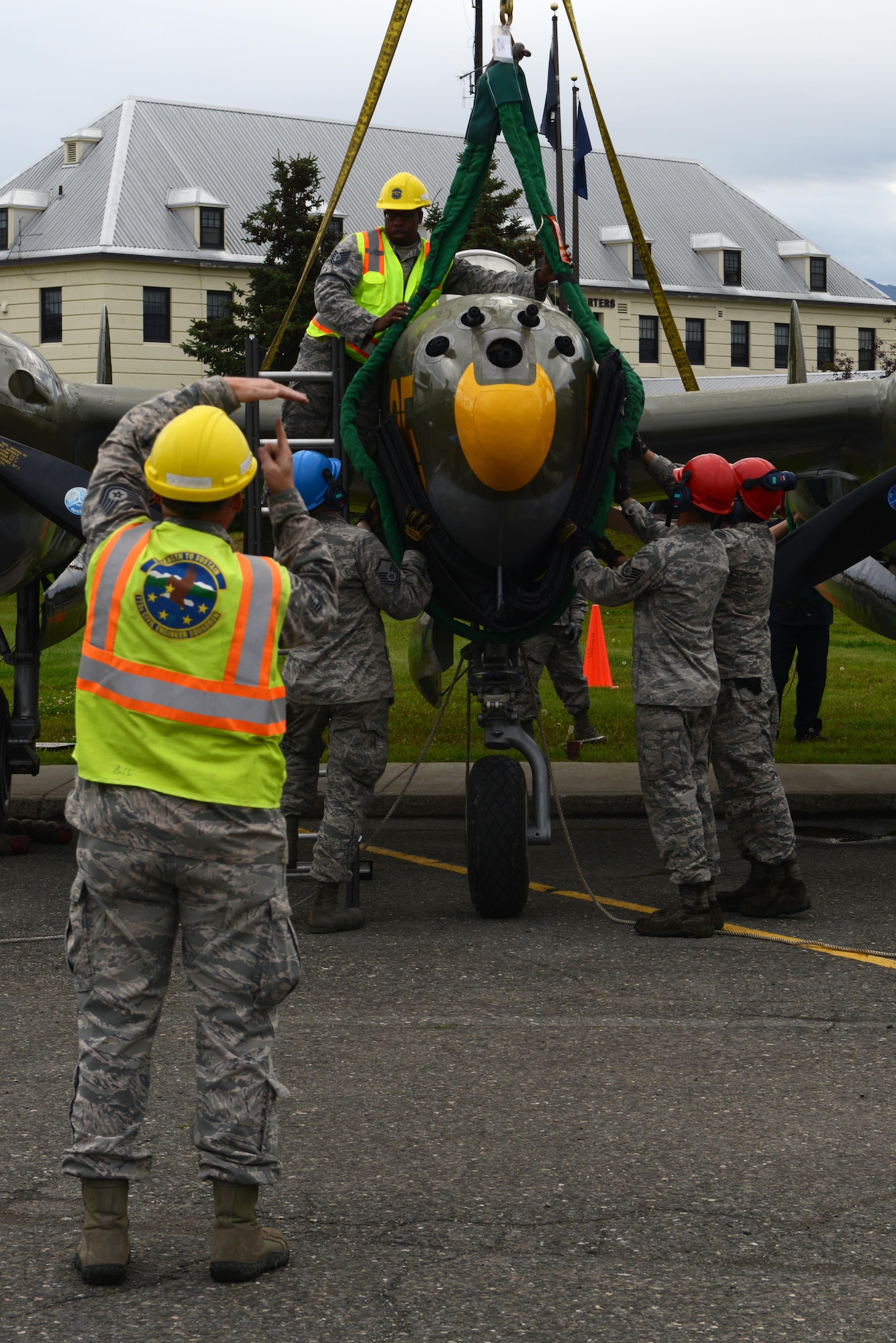The 3rd Maintenance Squadron crash recovery team and 773d Civil Engineer Squadron structure shop return the newly refurbished Lockheed P-38 Lightning to the 3rd Wing at Joint Base Elmendorf-Richardson, Alaska, Aug. 26, 2017. The aircraft has been a static display at JBER since May of 2000 as a reminder of the sacrifices made in the ‘Forgotten War’ of the Aleutian Island chain; the restoration program started in August of 2016.