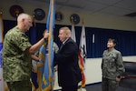 David Devlin, center, accepts the Defense Contract Management Agency Western Regional Command flag from Navy Vice Adm. David Lewis, the DCMA director. Devlin relieved Air Force Col. Alice Trevino, right, during an Aug. 28 ceremony at the regional headquarters in Carson, California. (DCMA photo by Mark Jackson)