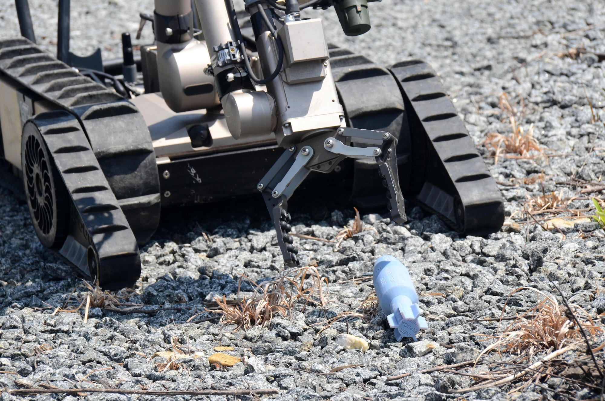 An explosive ordnance disposal robot reaches for a simulated explosive device during this year's Eastern National Robot Rodeo at Dobbins Air Reserve Base, Ga. Aug. 21, 2017. In designing the different training scenarios for the event, evaluators relied on a variety of locations both on and off base to provide realistic situations for testing the robots’ capabilities. (U.S. Air Force photo/Don Peek)