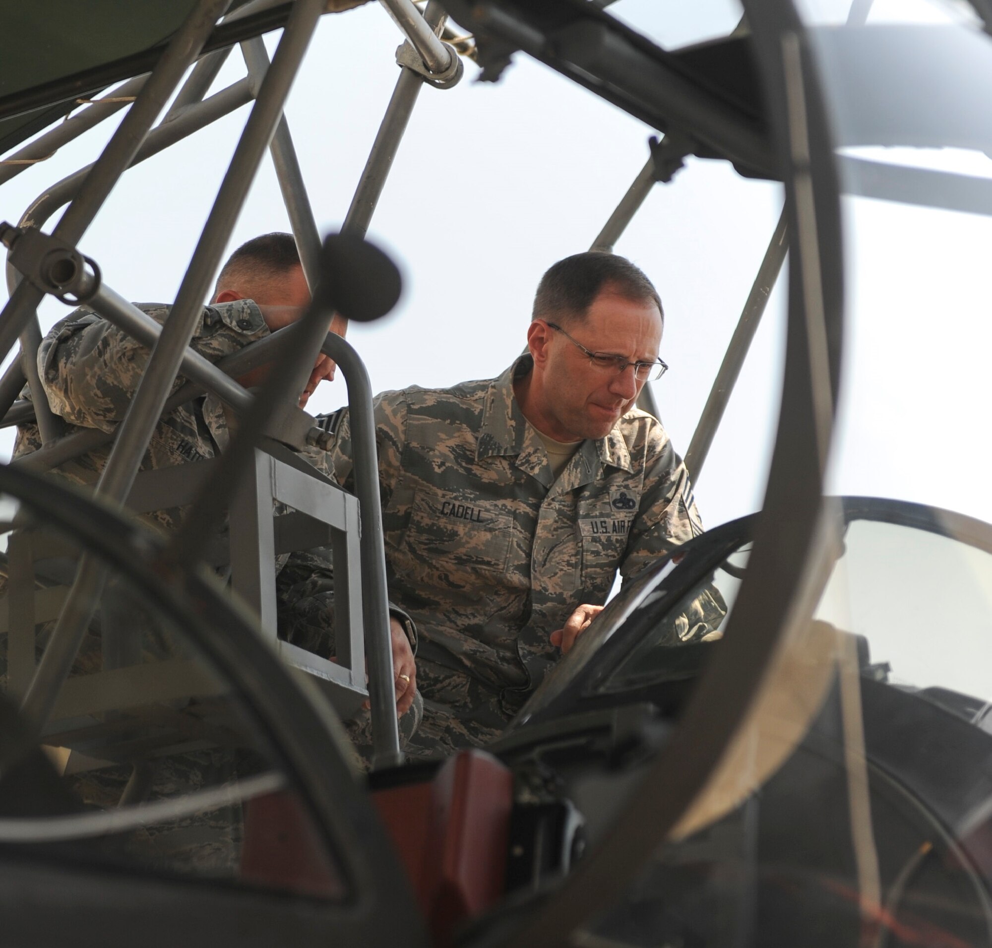 Chief Master Sgt. Stanley Cadell, 25th Air Force command chief, observes instruments of a U-2 Dragon Lady training aircraft.