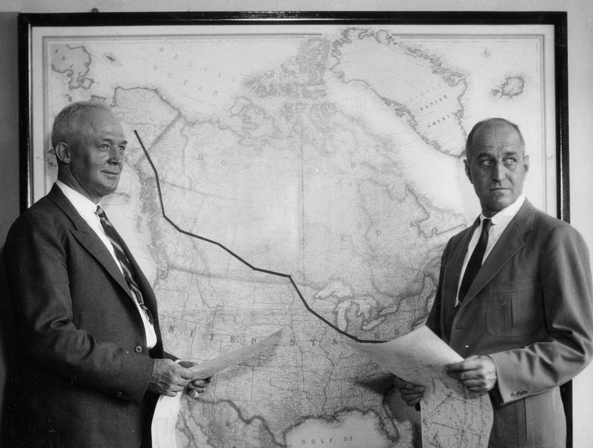 Lt. Col. H.H. Arnold, Commanding Officer of Alaskan Flight and Maj. Ralph Royce, Operations Officer studying maps that will guide flight to Alaska.