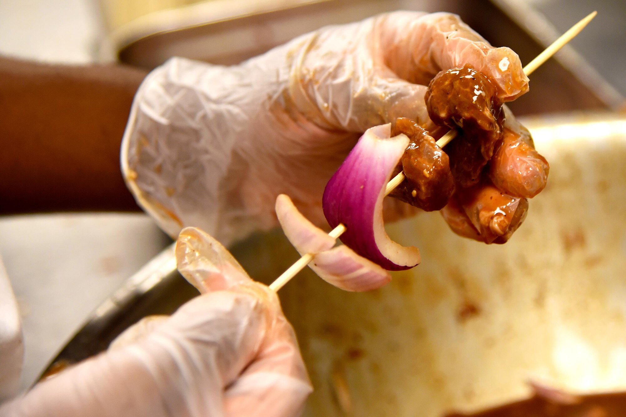 Airman 1st Class Germaine Williams, 23d Force Support Squadron services specialist, places beef on a shish kabob during the Georgia Pines Top Chef competition, Aug. 28, 2017, at Moody Air Force Base, Ga. The morning and evening shifts competed against each other with the winning team receiving the title of “Top Chef” along with a day off from work. (U.S. Air Force photo by Airman Eugene Oliver)