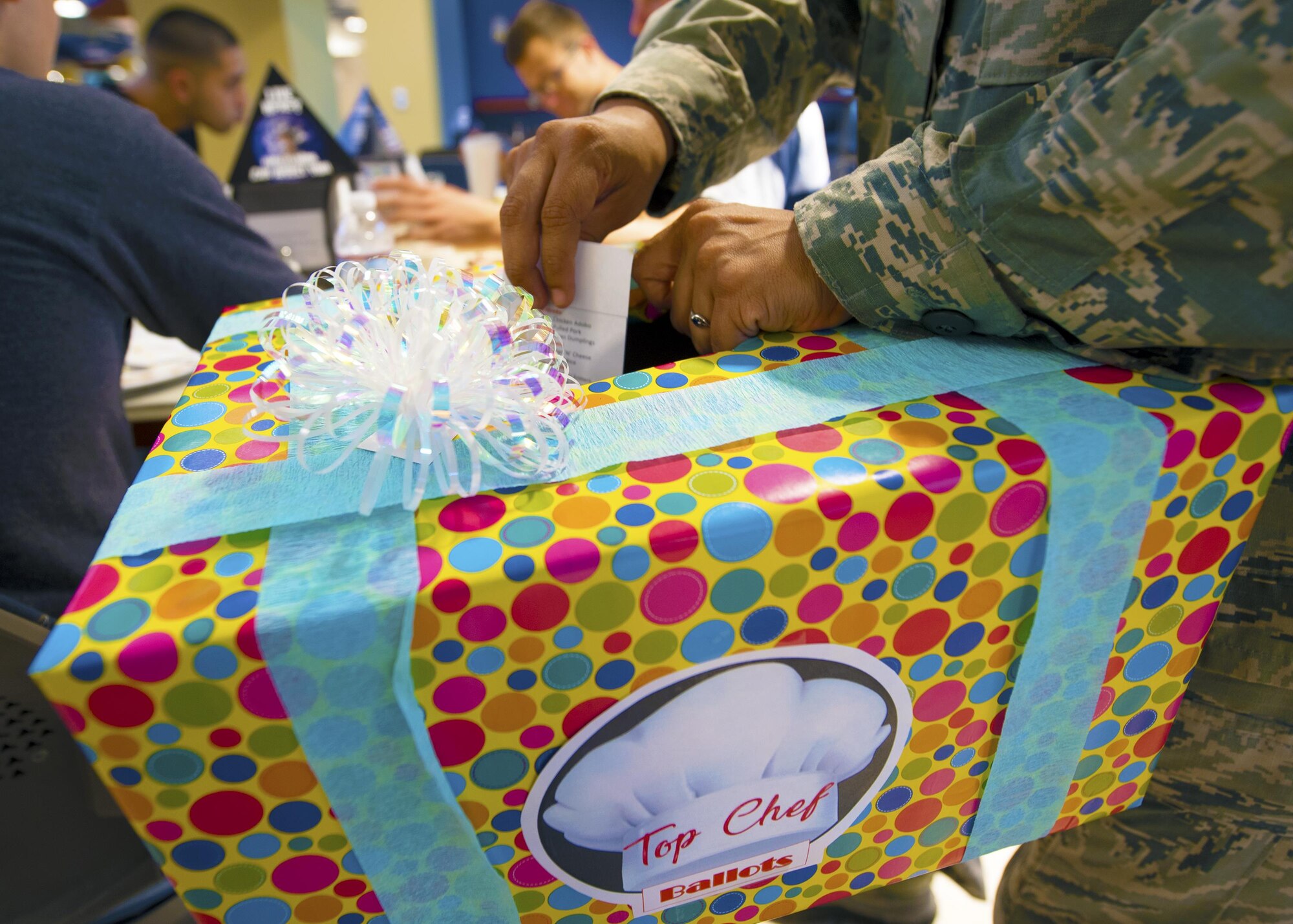 A Georgia Pines guest places a score card in a box during the “Top Chef” competition, Aug. 28, 2017, at Moody Air Force Base, Ga. The morning and evening shifts competed against each other with the winning team receiving the title of “Top Chef” along with a day off from work. (U.S. Air Force photo by Airman Eugene Oliver)
