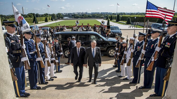 Defense Secretary Jim Mattis walks up the Pentagon steps with South Korea's defense minister.