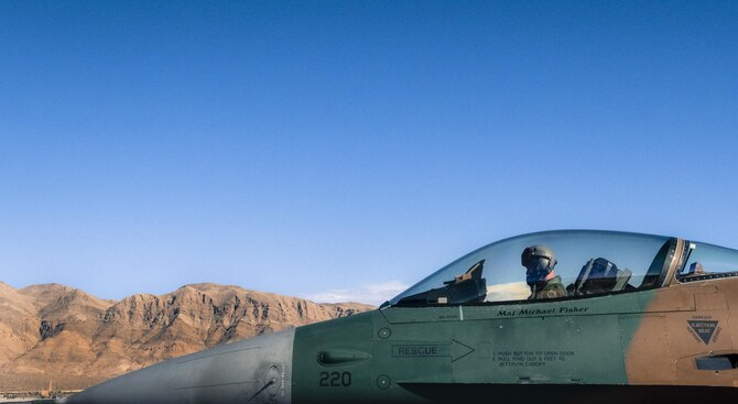 A 64th Aggressor Squadron pilot sits in an F-16 Fighting Falcon after a Red Flag 17-4 sortie on Nellis Air Force Base, Nev. Aug. 25, 2017. The 64th ARGS also supports the U.S. Air Force Weapons School and Mobile Training Teams to develop exceptional leaders and provide flying support. (U.S. Air Force photo/Senior Airman Kevin Tanenbaum)