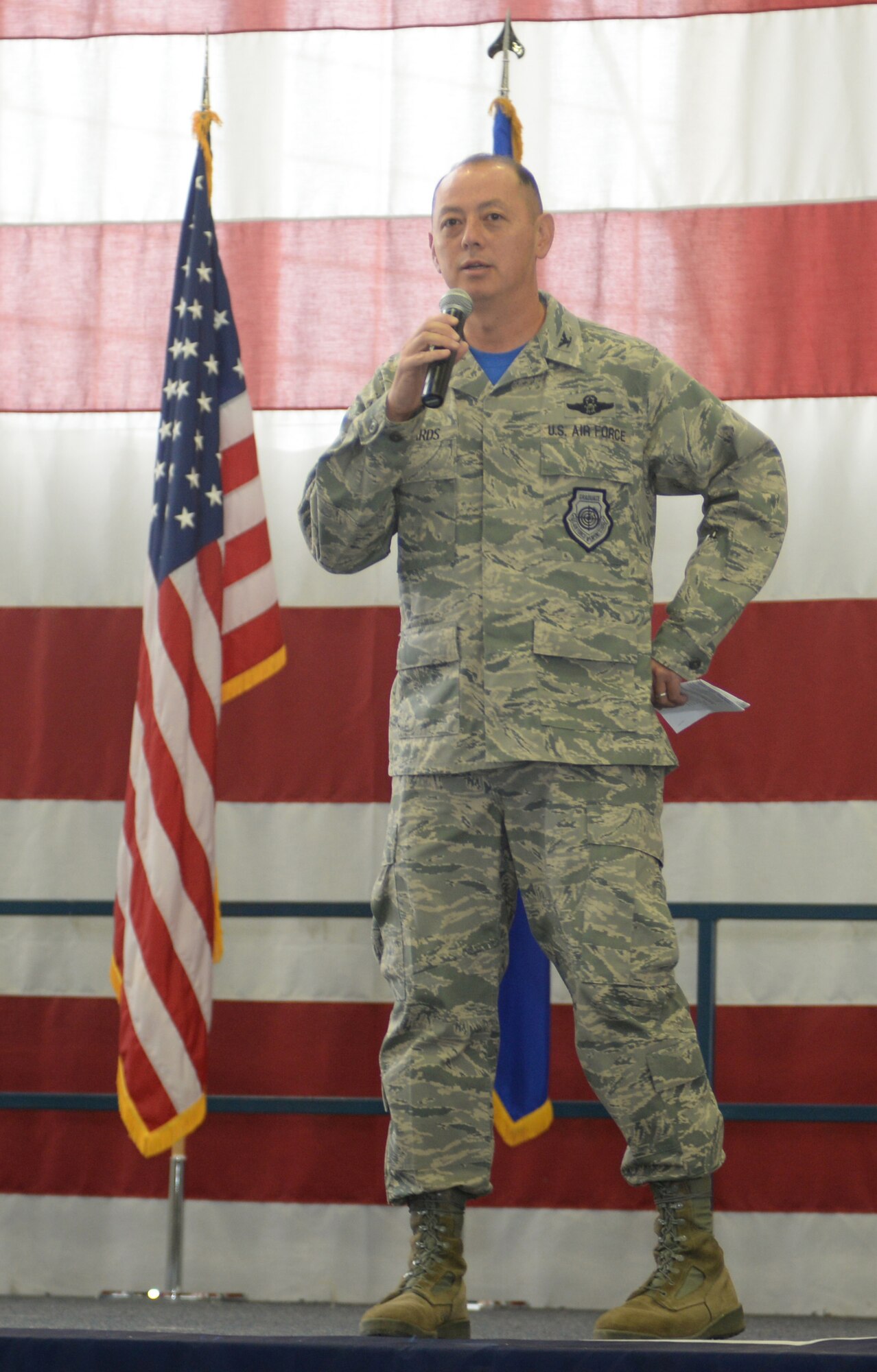 Col. Edwards, the 28th Bomb Wing Commander, delivers a speech to Airmen during Wingmen Day Aug. 25, 2017 on Ellsworth Air Force Base, S.D. The Wing Commanders All Call and kicked off the day’s events which included lectures and a base picnic called the Summer Bash. (U.S. Air Force photo by Airman 1st Class Thomas Karol)