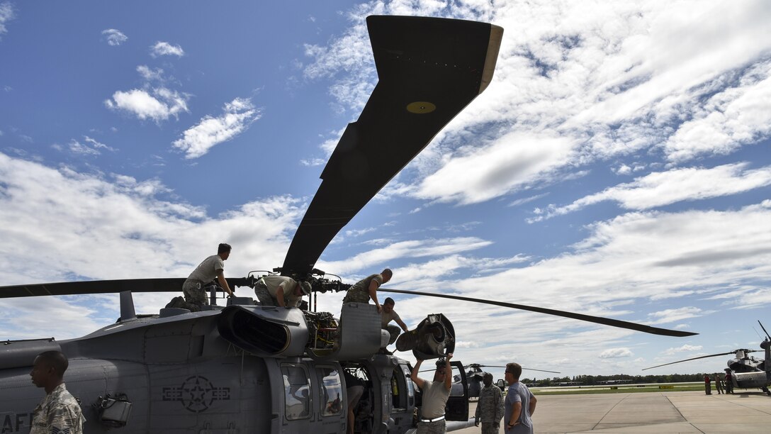 Airmen prepare a Pave Hawk helicopter for a rescue mission