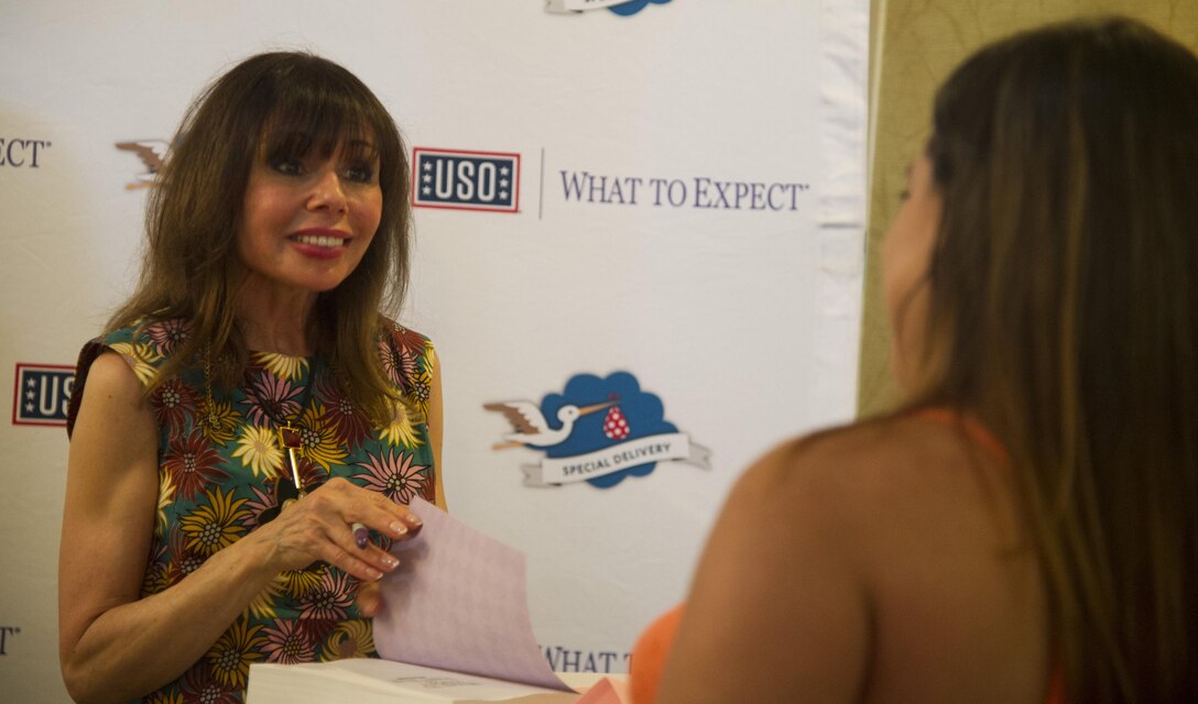 Heidi Murkoff, author of the What to Expect When You’re Expecting series, signs books during the USO “Special Delivery” baby shower, Joint Base Pearl Harbor-Hickam, Hawaii, Aug. 29, 2017.