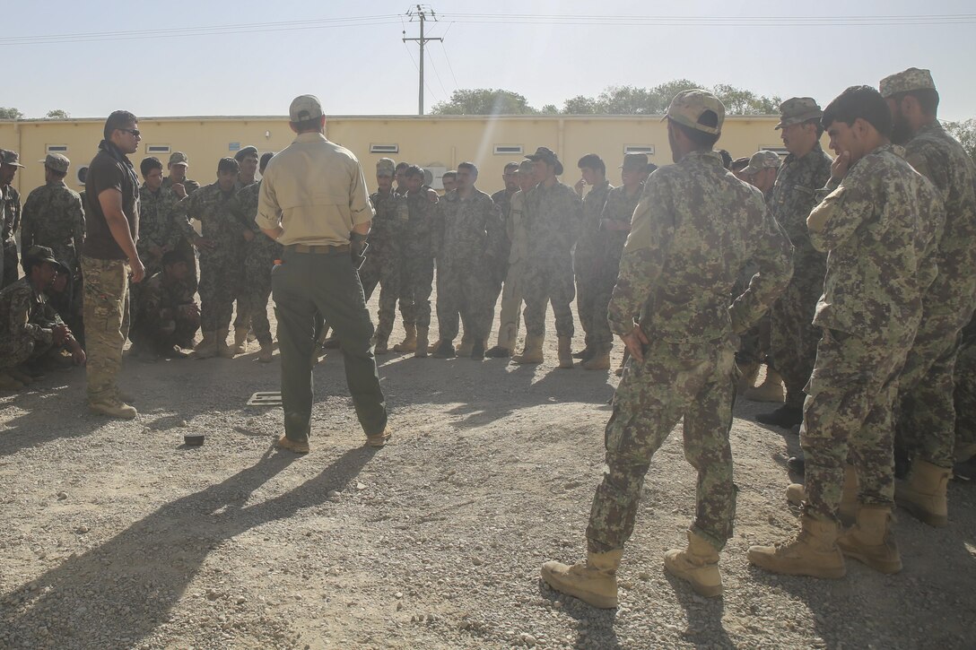 A counter improvised explosive device instructor teaches Afghan National Army soldiers with 215th Corps proper minesweeping procedures at Camp Shorabak, Afghanistan, Aug. 29, 2017. Approximately 70 engineer soldiers with various units from 215th Corps graduated from a route clearance course Aug. 30. Led by U.S. advisors, the curriculum focused on developing the Afghan’s tactics and procedures when locating and clearing IEDs, helping to improve mobility of troops and supplies on the battlefield. (U.S. Marine Corps photo by Sgt. Lucas Hopkins)
