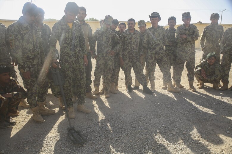 An Afghan National Army soldier with 215th Corps sweeps for notional improvised explosive devices at Camp Shorabak, Afghanistan, Aug. 29, 2017. Approximately 70 Afghan soldiers from throughout Helmand province completed a route clearance course held at the Helmand Regional Military Training Center Aug. 30. Led by U.S. advisors, the eight-week course developed the soldiers’ route clearance capabilities through classroom instruction and practical application exercises, resulting for improved mobility amongst infantry kandaks and supplies across the region. (U.S. Marine Corps photo by Sgt. Lucas Hopkins)