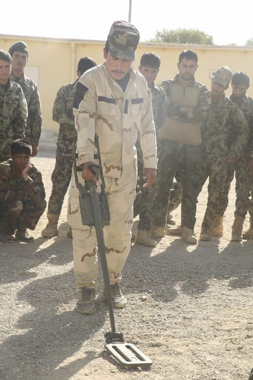 An Afghan National Army soldier with 215th Corps sweeps for notional improvised explosive devices at Camp Shorabak, Afghanistan, Aug. 29, 2017. Approximately 70 soldiers with units across Helmand province completed a route clearance course led by U.S. advisors Aug. 30. Throughout the eight-week training program, the soldiers developed their route clearance tactics, techniques and procedures as a means to enhance mobility of infantry units and supply chains on the battlefield. (U.S. Marine Corps photo by Sgt. Lucas Hopkins)