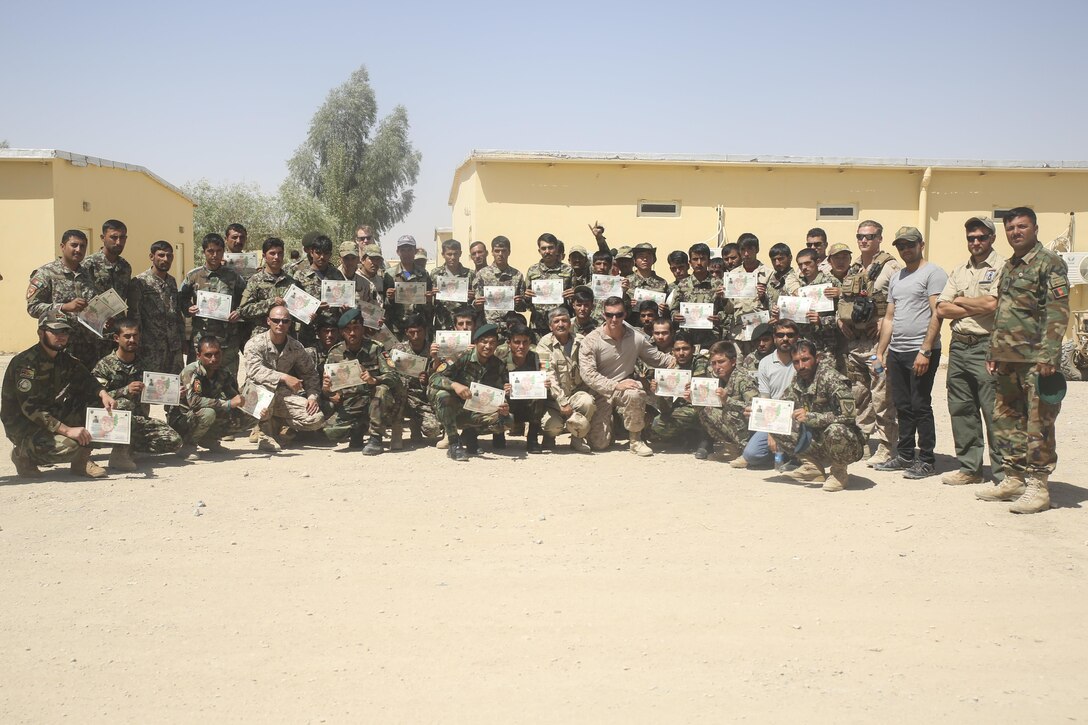 U.S. Marine advisors with Task Force Southwest and Afghan National Army soldiers with 215th Corps pose for a photo following a graduation ceremony at Camp Shorabak, Afghanistan, Aug. 30, 2017. Approximately 70 soldiers with units across Helmand province completed a route clearance course led by U.S. advisors. Throughout the eight-week training program, the soldiers developed their route clearance tactics, techniques and procedures as a means to enhance mobility of troops and supply chains on the battlefield. (U.S. Marine Corps photo by Sgt. Lucas Hopkins)