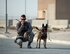 U.S. Air Force Staff Sgt. Timothy Dawson, a military working dog handler with the 379th Expeditionary Security Forces Squadron, radios in suspicious activity during a vehicle search exercise at Al Udeid Air Base, Qatar, Aug. 26, 2017. Dawson and his military working dog Mmaura are taking part in a vehicle search exercise with the 379th Expeditionary Civil Engineer Squadron Explosive Ordnance Disposal Flight where Mmaura detected something abnormal with the vehicle. (U.S. Air Force photo by Tech. Sgt. Amy M. Lovgren)