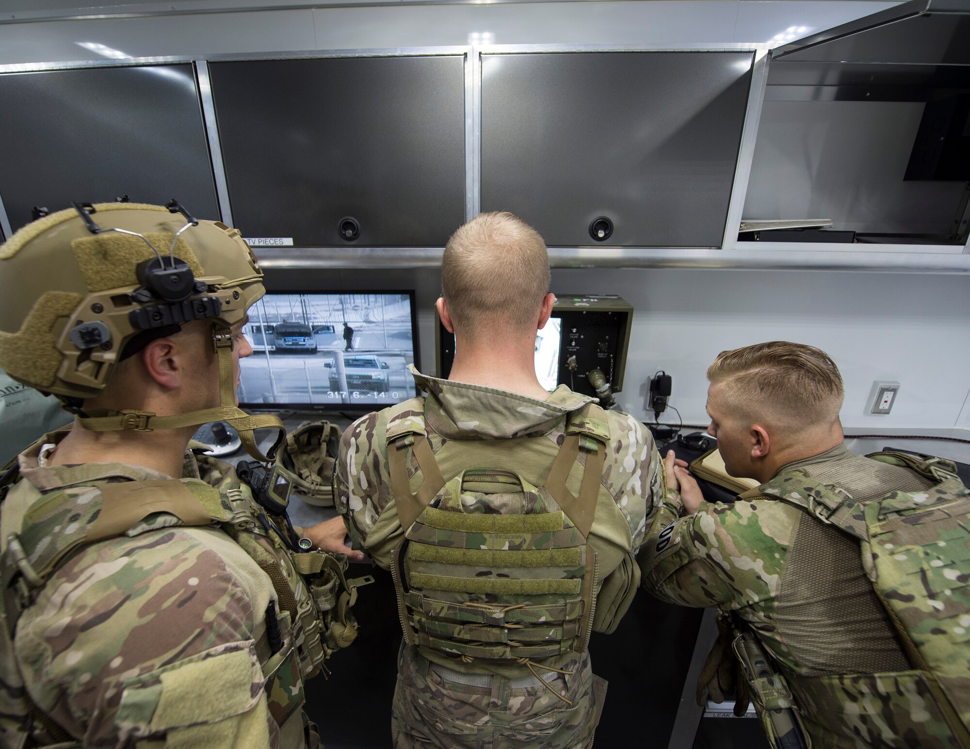 U.S. Air Force Staff Sgt. Brian Vosper, left, team leader, Senior Airman Luke Bryant, team member and robot operator, and Staff Sgt. Weston Cobb, team member, with the 379th Expeditionary Civil Engineer Squadron Explosive Ordnance Disposal Flight, reviews camera footage from a Remotec ANDROS F6A heavy-duty robot at Al Udeid Air Base, Qatar, Aug. 26, 2017.