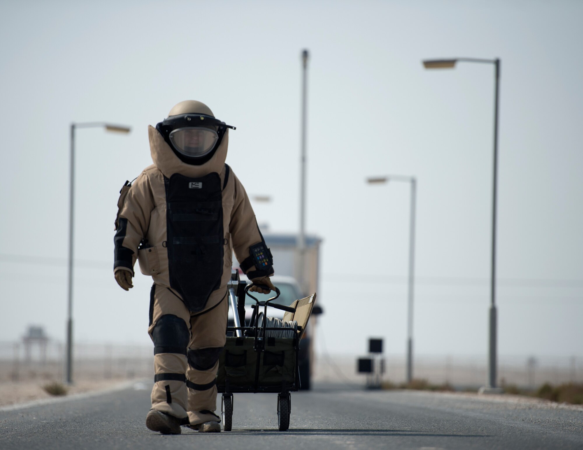U.S. Air Force Staff Sgt. Brian Vosper, team leader with the 379th Expeditionary Civil Engineer Squadron Explosive Ordnance Disposal Flight, walks to the vehicle search exercise location at Al Udeid Air Base, Qatar, Aug. 26, 2017.