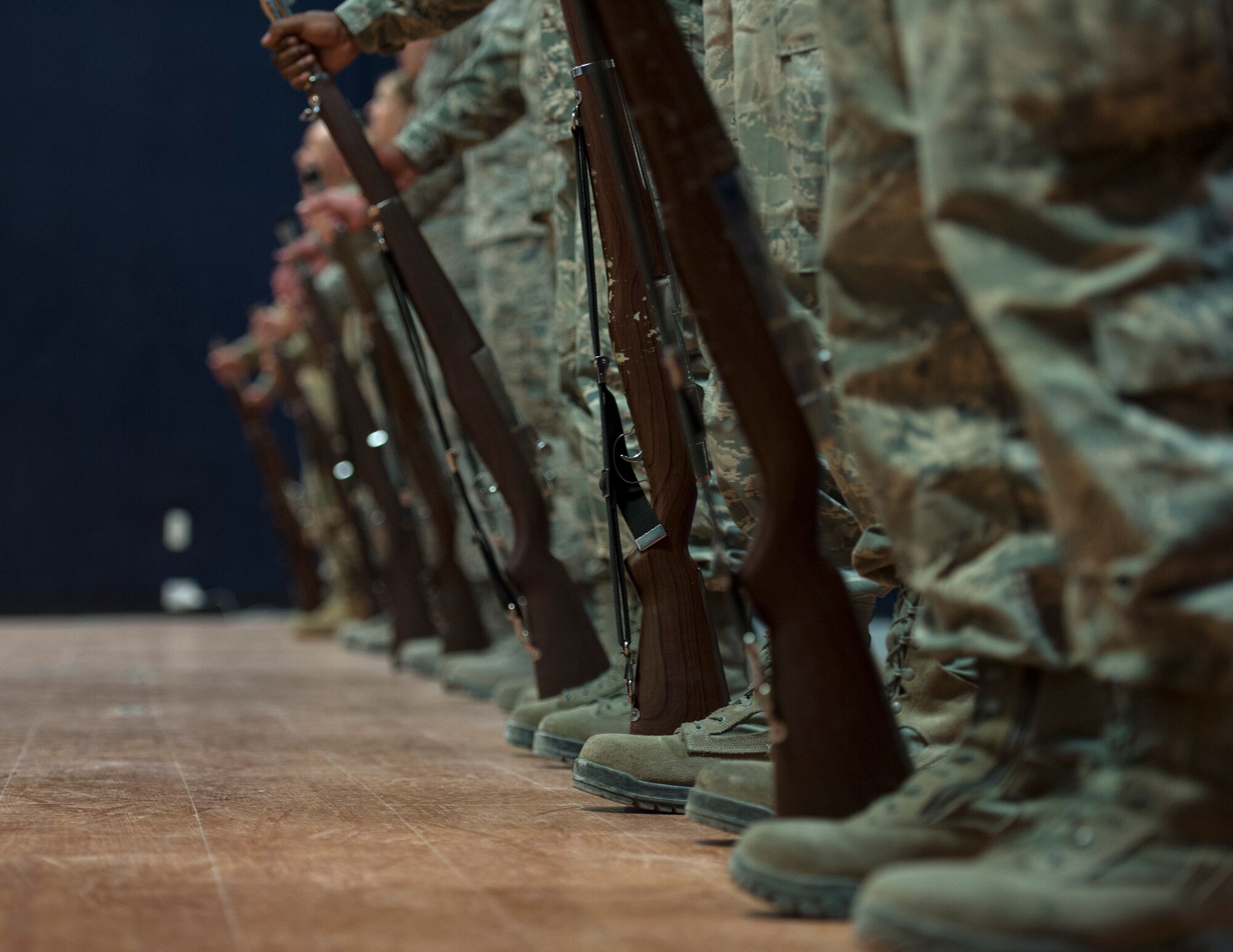 U.S. Air Force Airmen with the 379th Air Expeditionary Wing stand at parade rest with rifles at Al Udeid Air Base, Qatar, Aug. 9, 2017.