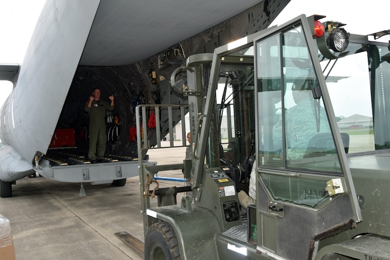 A U.S. Coast Guardsman assists members of the 127th Logistics Readiness Squadron, Small Air Terminal, in loading cargo onto a C-27 Spartan in advance of a deployment here on Tuesday. The 127th Wing, command unit of Selfridge Air National Guard Base, provided the expertise and equipment to U.S. Coast Guard Air Station Detroit, a longstanding active-duty unit based here since 1966.