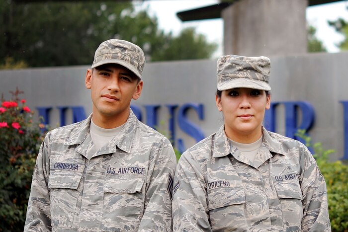 A man and women in Air Force gear sit next to eachother.