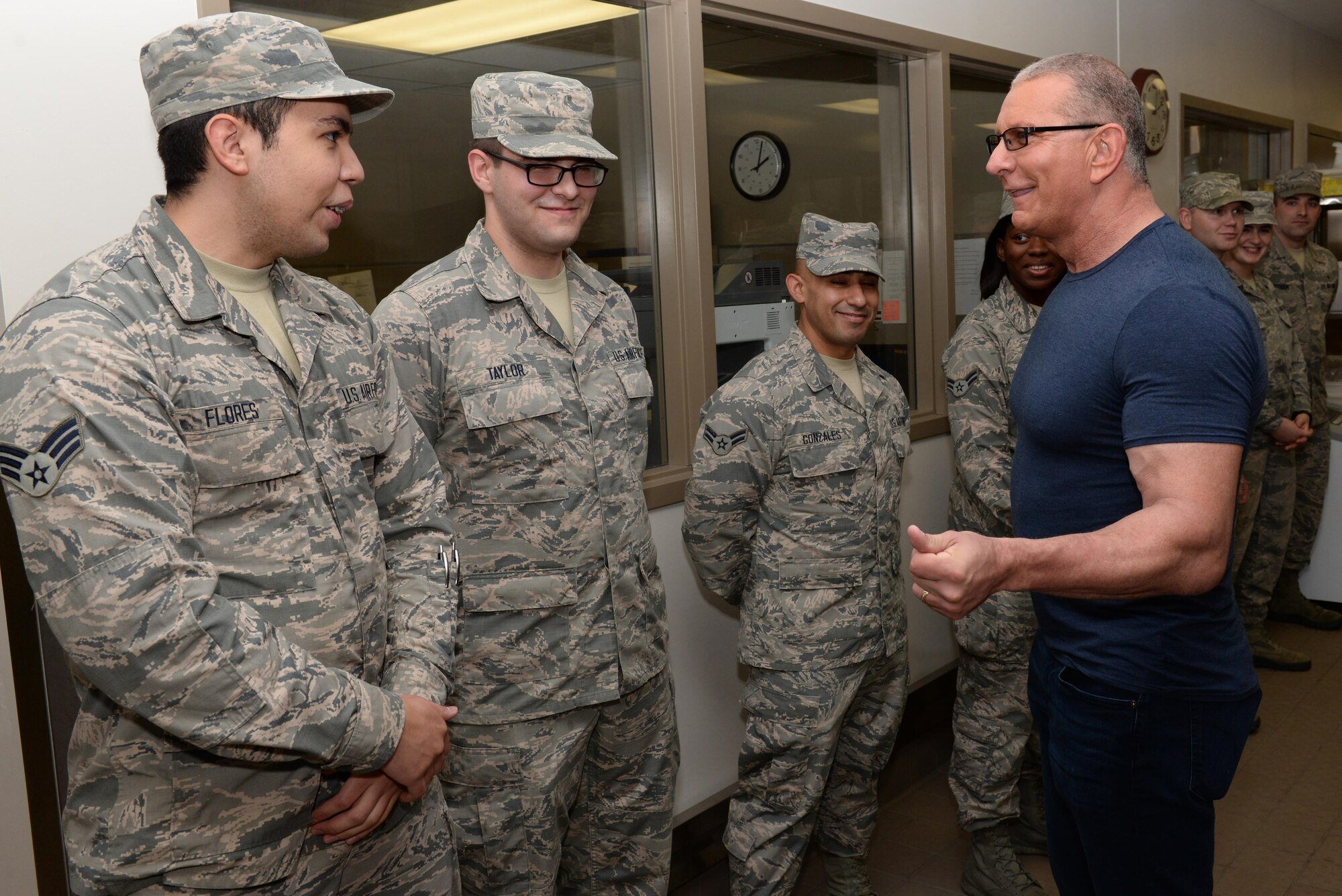 Celebrity chef Robert Irvine talking with Airmen