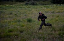 Airman running through field