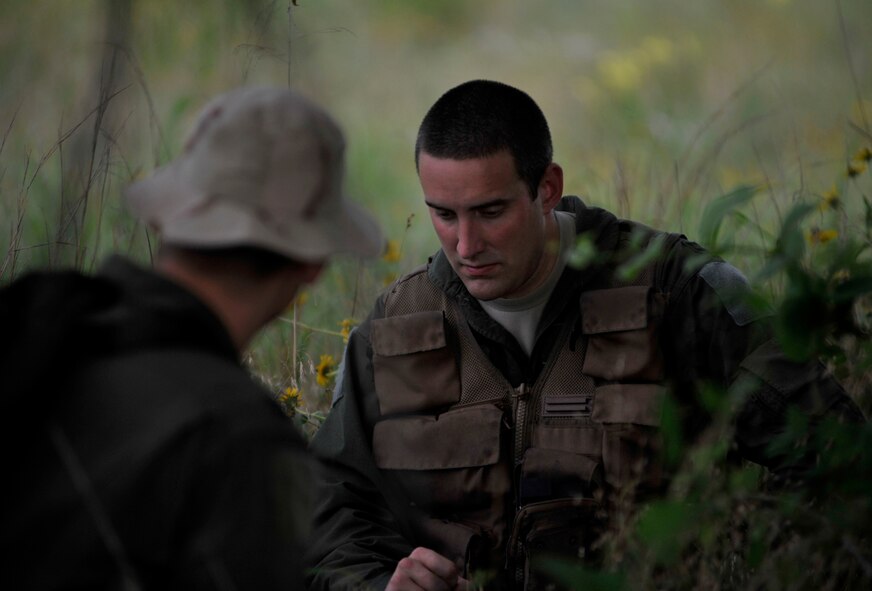 Airmen sitting under tree