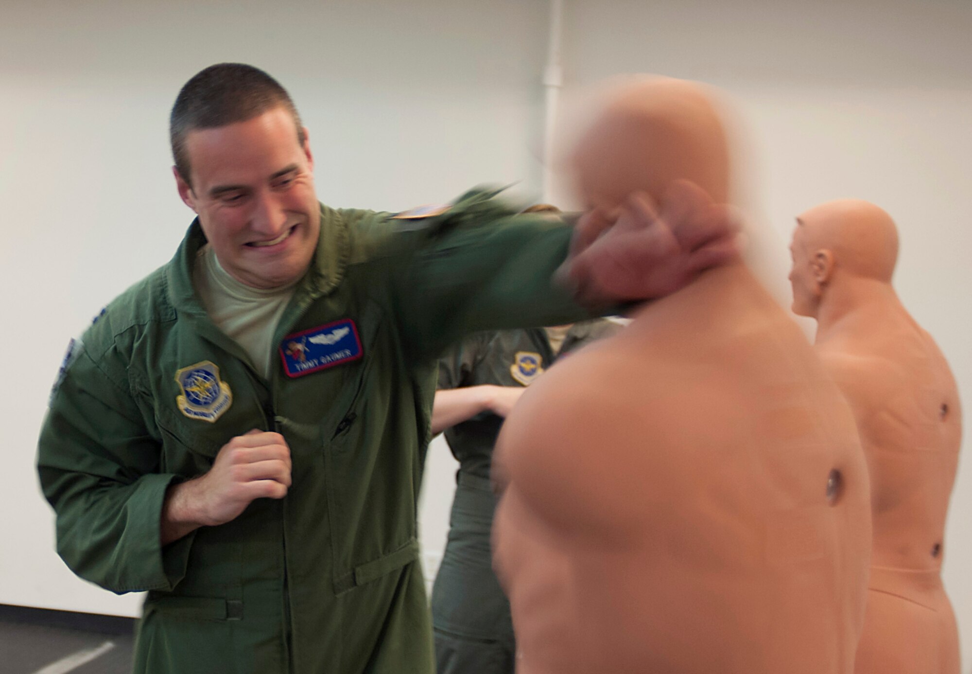 Airman practices combatives with dummy