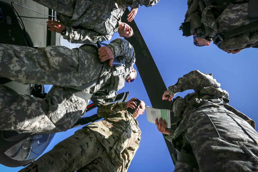 Army National Guardsmen go over flight plans before departing Joint Base McGuire-Dix-Lakehurst
