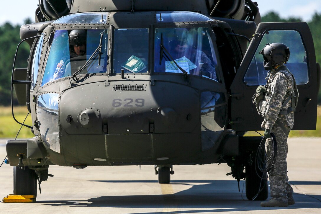 Army crew chief performs the final checks before departing Joint Base McGuire-Dix-Lakehurst