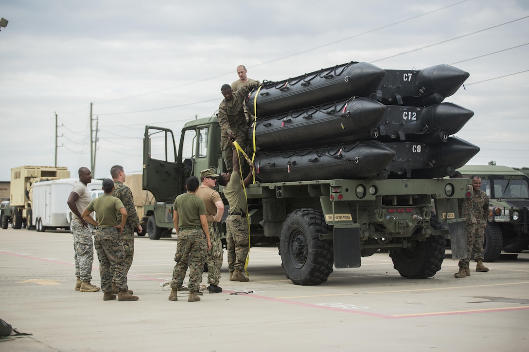 KATY, Texas – Marines with Charlie Company, 4th Reconnaissance Battalion, 4th Marine Division, Marine Forces Reserve, tie down U.S. Marine Corps F470 Zodiacs Combat Rubber Raiding crafts on to a U.S. Army 1078 A1 Truck at Katy High School in Katy, Texas, Aug. 30, 2017. Marines from Charlie Company supported rescue mission in the wake of Hurricane Harvey, which flooded much of the surrounding region displacing 30,000 people, and flooding thousands of homes. (U.S. Marine Corps photo by Lance Cpl. Niles Lee/Released)