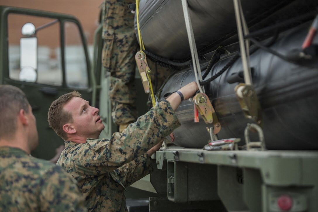 KATY, Texas – Marine Corps Sgt. Brad Coats, a reconnaissance Marine with Charlie Company, 4th Reconnaissance Battalion, 4th Marine Division, Marine Forces Reserve, ties down U.S. Marine Corps F470 Zodiac Combat Rubber Raiding crafts on a U.S. Army 1078 A1 Truck at Katy High School in Katy, Texas, Aug. 30, 2017. Marines from Charlie Company supported rescue mission in wake of Hurricane Harvey, which flooded much of the surrounding region displacing 30,000 people, and flooding thousands of homes. (U.S. Marine Corps photo by Lance Cpl. Niles Lee/Released)