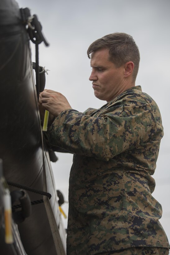 KATY, Texas – Marine Corps Sgt. Sean Hennessey, a water survival instructor with Charlie Company, 4th Reconnaissance Battalion, 4th Marine Division, Marine Forces Reserve, ties chemical lights to a U.S. Marine Corps F470 Zodiacs Combat Rubber Raiding craft at Katy High School in Katy, Texas, Aug. 30, 2017. Marines from Charlie Company supported rescue missions in wake of Hurricane Harvey, which flooded much of the surrounding region displacing 30,000 people, and flooding thousands of homes. (U.S. Marine Corps photo by Lance Cpl. Niles Lee/Released)