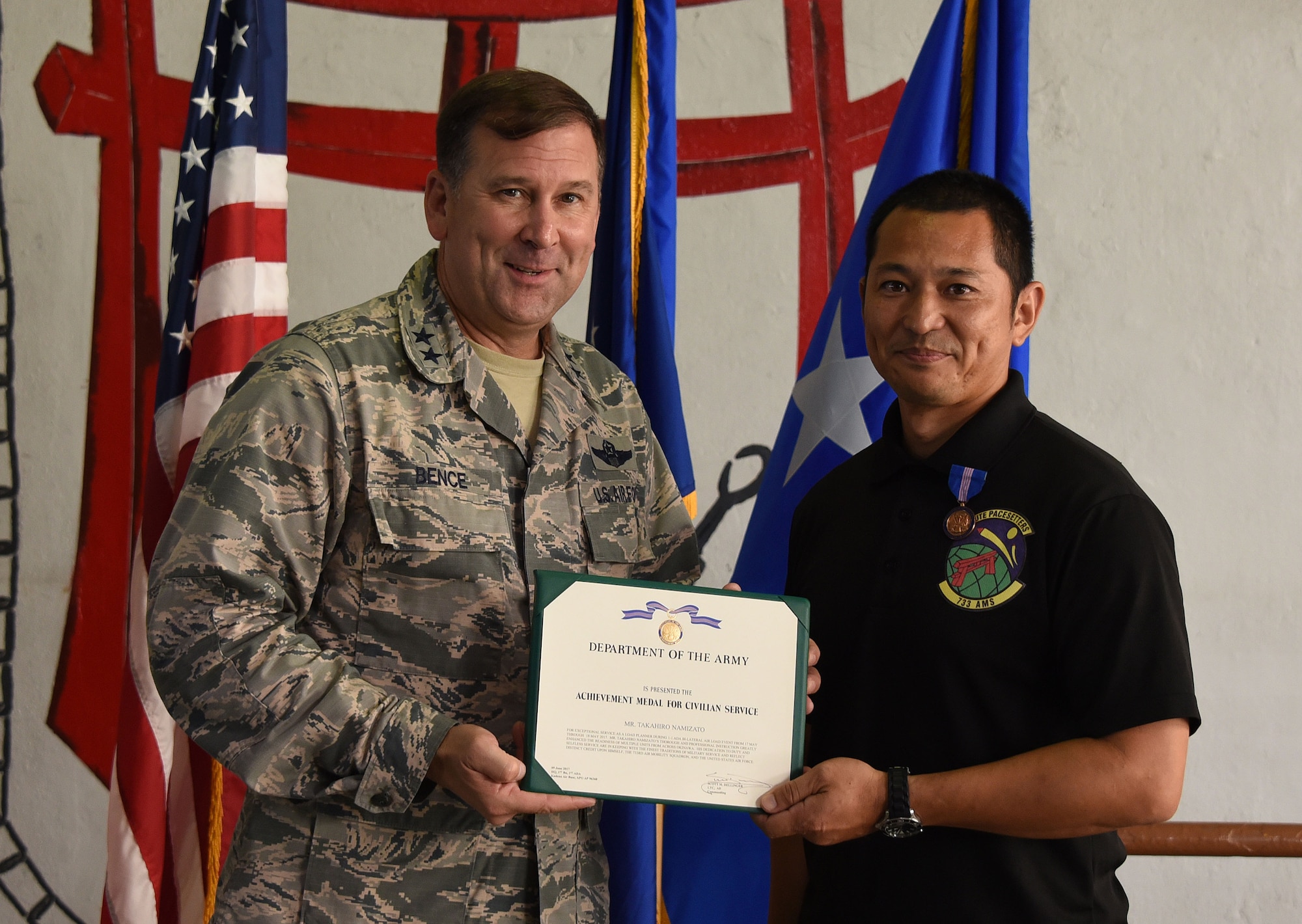 Maj. Gen. Christopher Bence, commander, USAF Expeditionary Center, awards the Army Achievement Medal to Takahiro Namizato for his contributions to a joint, bi-lateral air load exercise with the 1st Battallion, 1st Air Defense Artillery Regiment during a ceremony at Kadena Air Base, Japan, Aug. 23, 2017. (U.S. Air Force photo by Tech. Sgt. Jamie Powell)