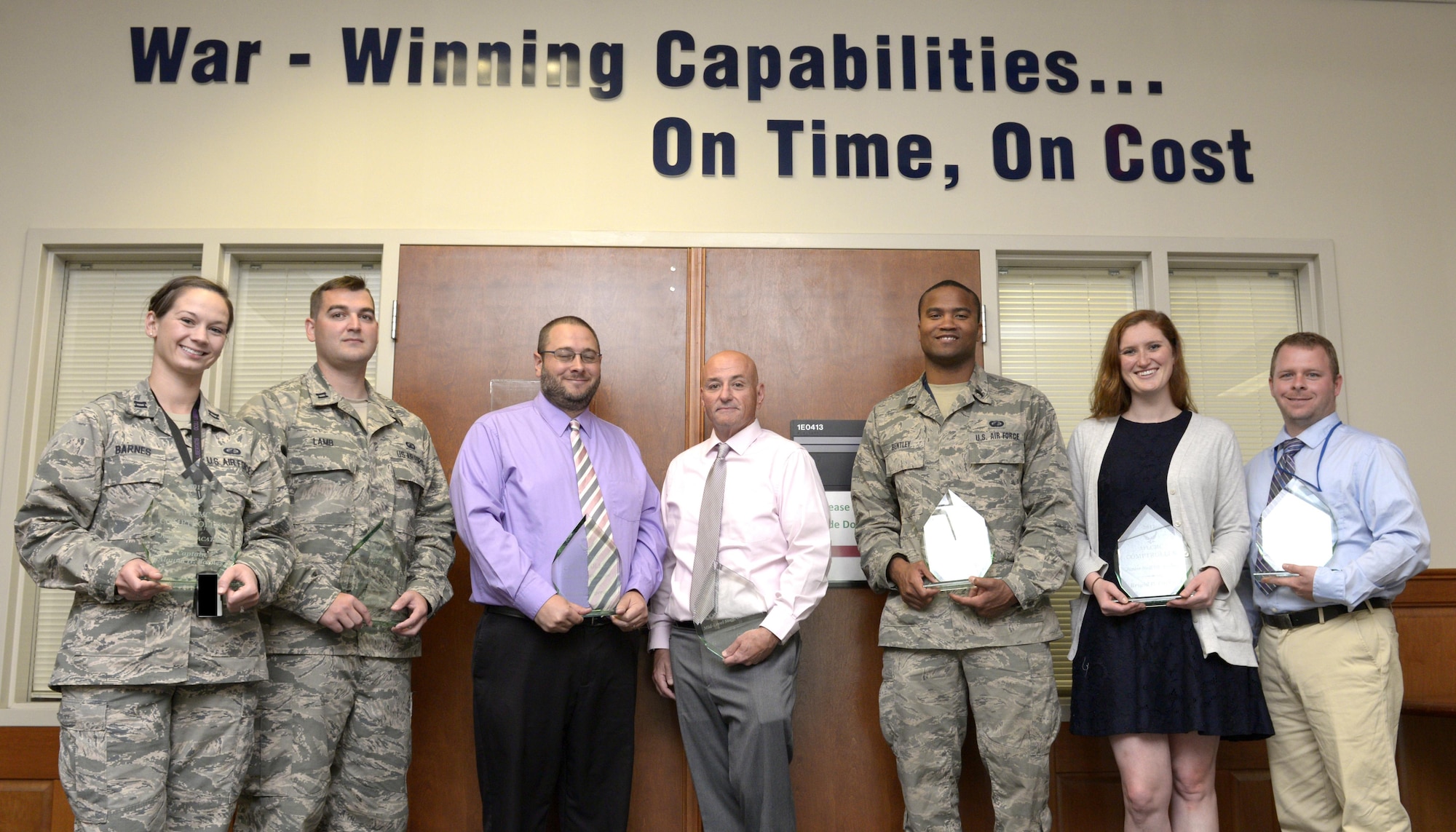 seven of the eight Hanscom Air Force Base, Mass., Financial Management Airmen who earned annual awards Aug. 29 for managing more than $4 billion in Air Force acquisitions.