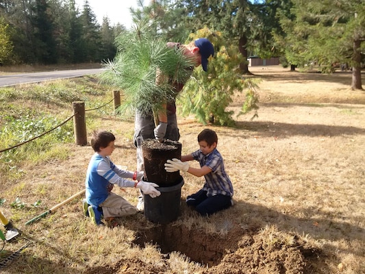 Bryce Johnson (left), DJ Evans (center) and Ben Evans, Cub Scout Pack 140 members, plant a tree during a National Public Lands Day event at Pine Meadows Campground, Cottage Grove Lake, southeast of Eugene, Oregon, Sept. 24, 2016. This year, the U.S. Army Corps of Engineers will hold a similar event at Schwarz Campground, below Dorena Dam. For their efforts, volunteers can camp for free.