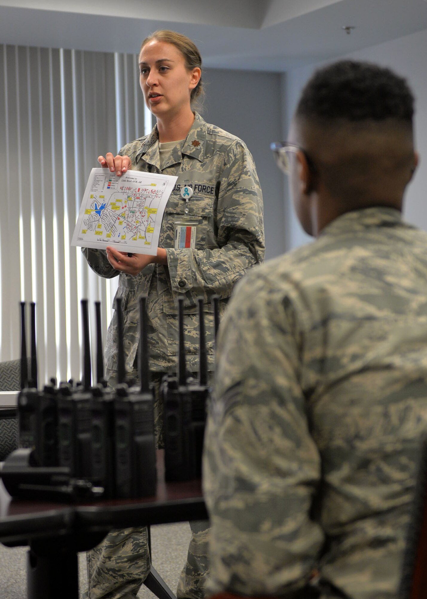 Maj. Rachel Copeland briefs airmen during an exercise Aug. 24, 2017, at Little Rock Air Force Base, Ark. The 19th Medical Group shuts its doors every month to prepare airmen for potentially real- life emergency scenarios. (U.S. Air Force photo by Airman 1st Class Codie Collins)