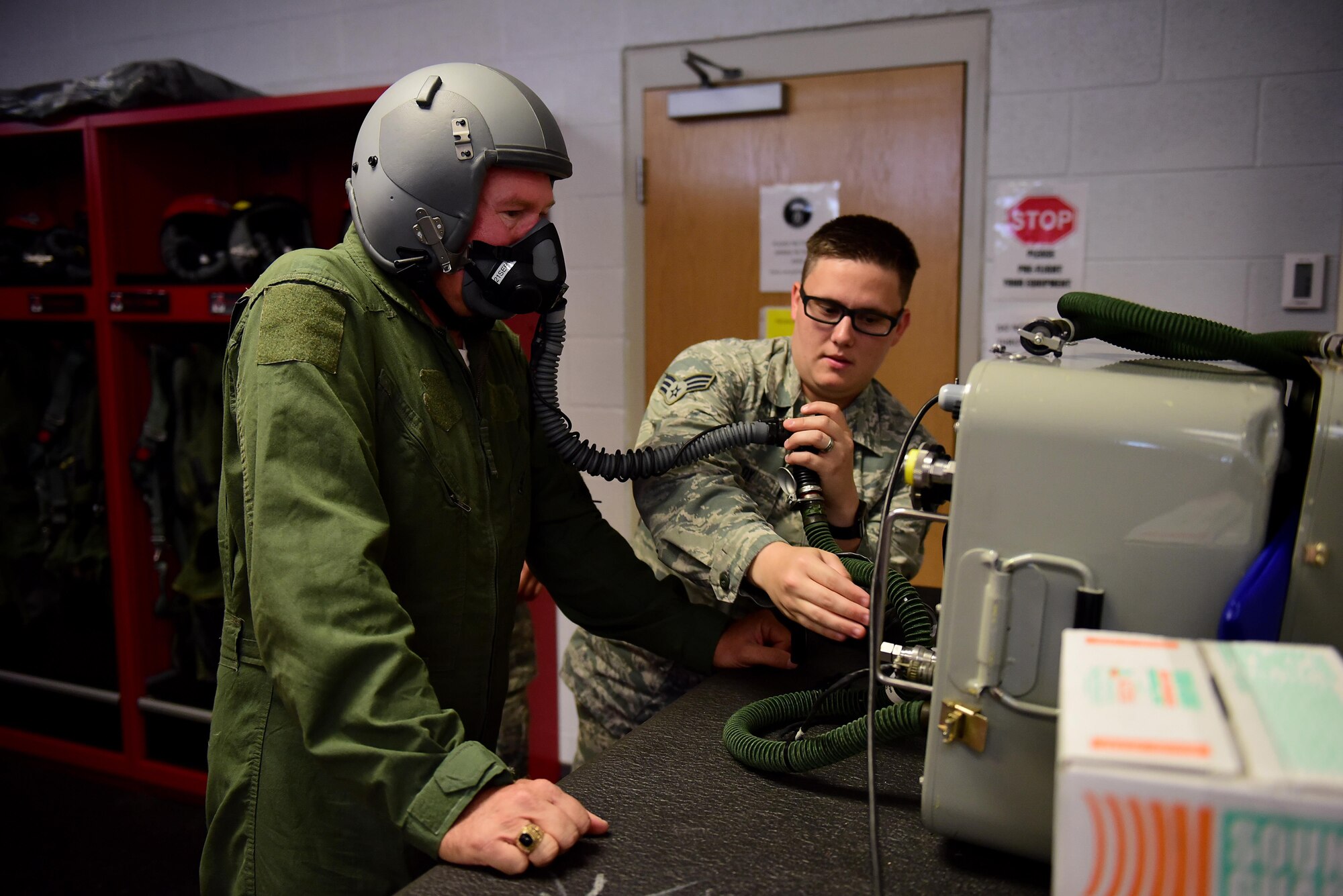 Richard Lambert, 4th Fighter Wing community support coordinator, left, wears an oxygen mask while Senior Airman Zachary Weldy, 4th Operations Support Squadron aircrew flight equipment technician, right, checks the seal to ensure no leaks are present, Aug. 28, 2017, at Seymour Johnson Air Force Base, North Carolina.