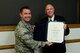 Col. Brian Armstrong, 4th Fighter Wing vice commander, presents the Outstanding Civilian Career Service Award to Richard Lambert, 4 FW community support coordinator during Lambert’s retirement ceremony, Aug. 29, 2017, at Seymour Johnson Air Force Base, North Carolina.