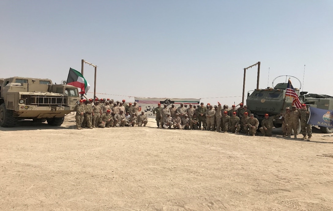 U.S. Soldiers from the 169th Field Artillery Brigade, and the Kuwait Land Force’s 22nd Artillery Battalion, pose for a photo at the conclusion of Spartan Thunder, Aug. 17, KLF Artillery Base, Kuwait. Spartan Thunder, a first of its kind military to military exercise, focused on developing field artillery interoperability, creating enduring security partnerships, and fostering regional peace and stability.