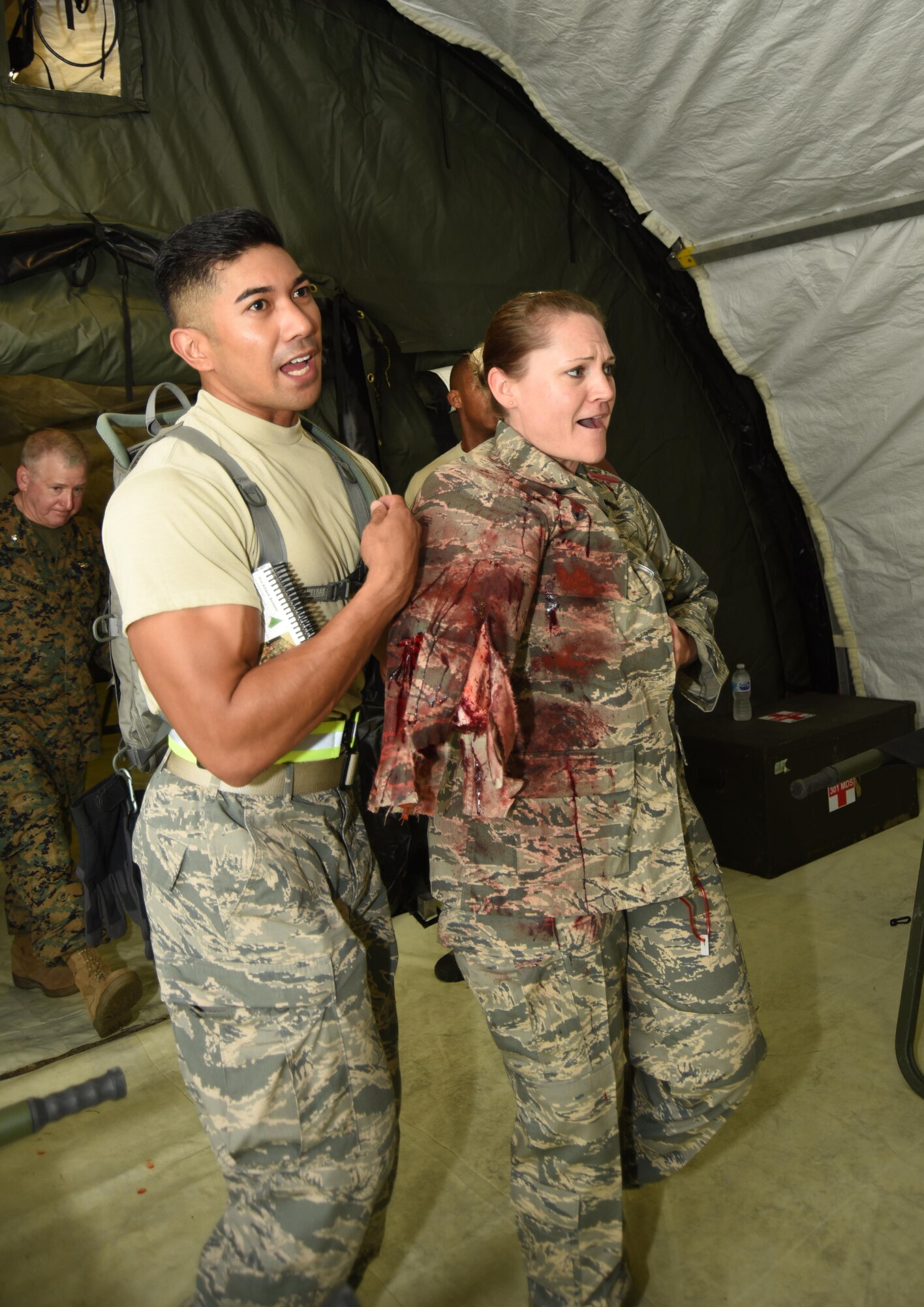 U.S. Air Force Tech. Sgt. Bobby Ramirez escorts Air Force Staff Sgt. Sara Oren, both assigned to the 301st Medical Squadron, into a simulated deployed hospital for patient care Aug. 19, 2017, here during the unit’s mass casualty exercise. Airmen, Sailors and Marines participated in the joint forces readiness exercise to enhance their ability to collaborate effectively in planning and implementing of rapid medical interventions. (U.S. Air Force photo by Maj. Candice Allen)