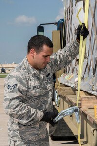 Senior Airman Vines, Taylor, 502nd Logistics Readiness Squadron, secures pallets loaded with medical supplies and equipment to a flatbed truck