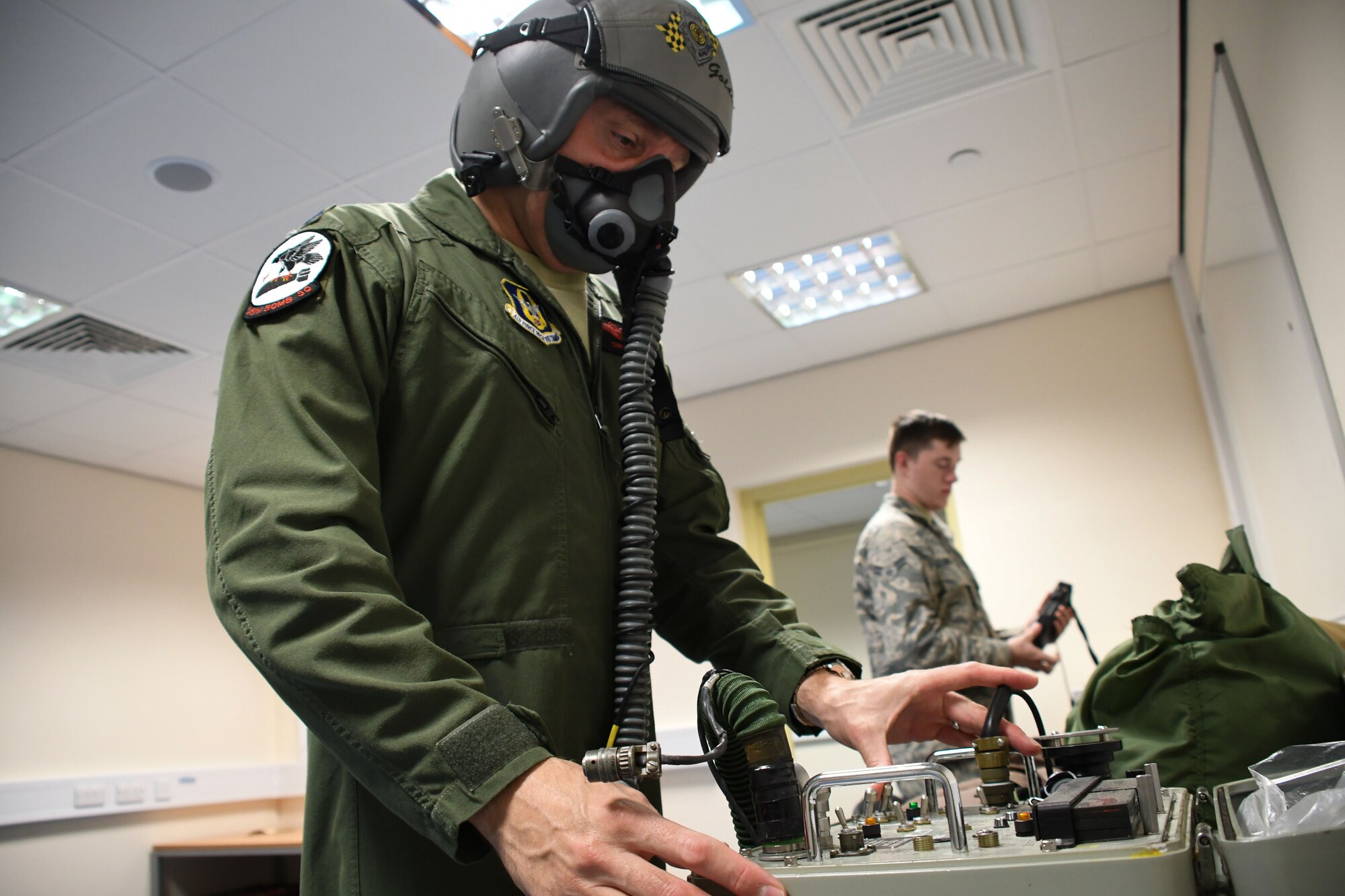 U.S. Air Force Lt. Col. Christopher Hawn, 489th Bomb Group deputy commander, tests his oxygen mask at RAF Fairford, U.K., Aug. 29, 2017.