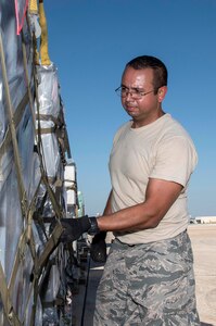 Staff Sergeant Eric Reyes, Air Medical Operations Agency, ensures pallets loaded with medical supplies and equipment are secure