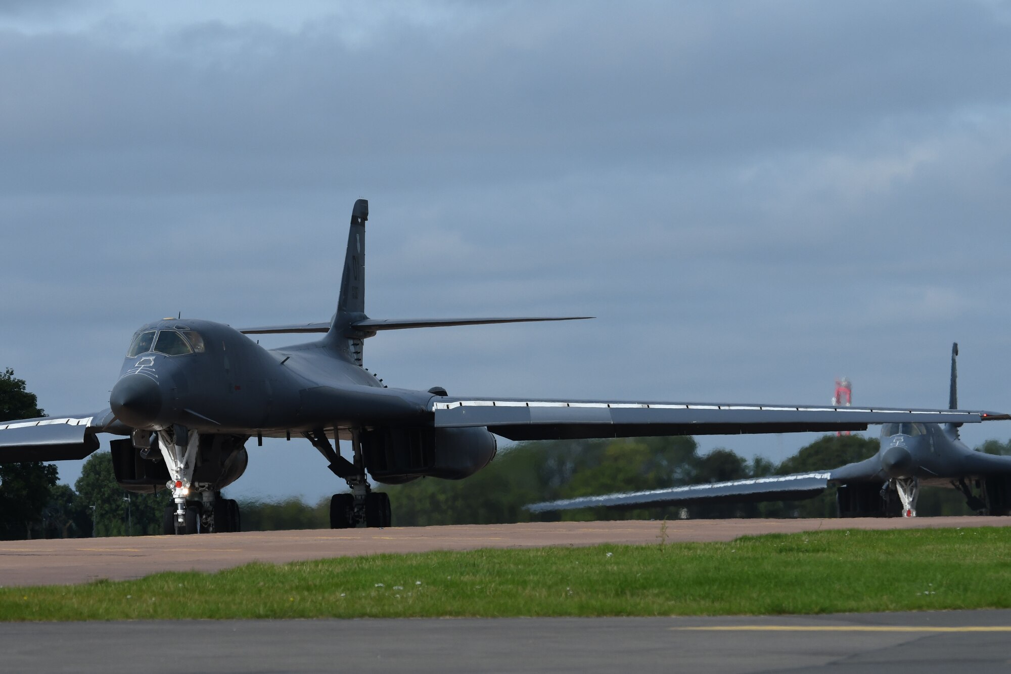 Air Force pilots from the 489th Bomb Group taxi two B-1 Lancers to the runway at RAF Fairford, U.K., Aug. 29, 2017.