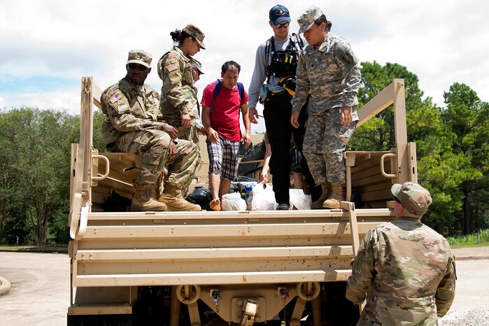 Texas Army National Guardsmen prepare to unload residents stranded by flooding caused by Harvey in Sugar Land, Texas