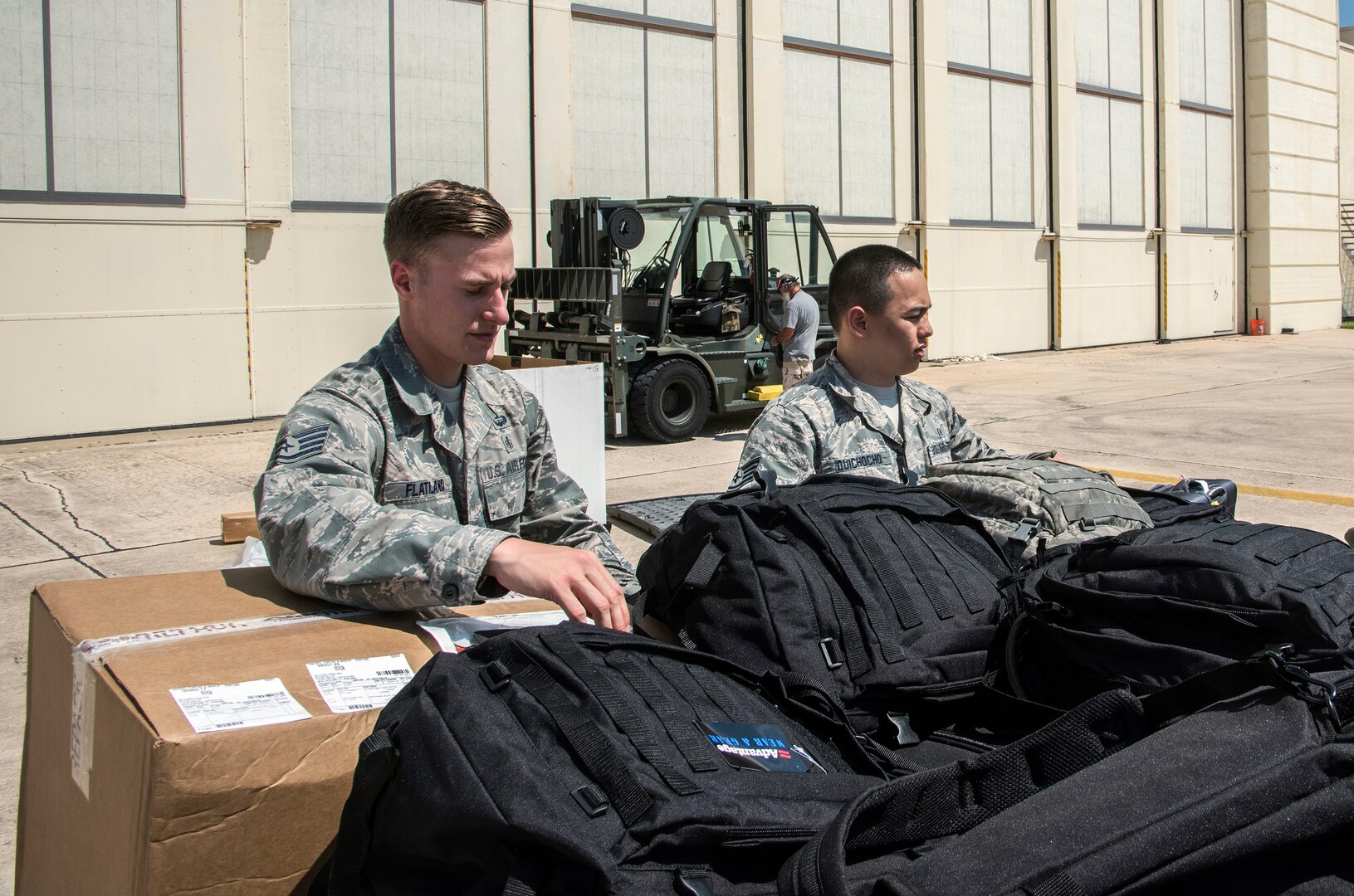 Airmen from the 59th Medical Wing prepare deployment bags for transport Aug. 30, 2017 at Joint Base San Antonio-Lackland, Texas.