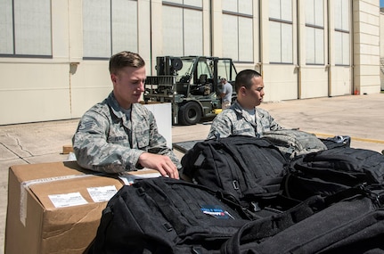 Airmen from the 59th Medical Wing prepare deployment bags for transport Aug. 30, 2017 at Joint Base San Antonio-Lackland, Texas.